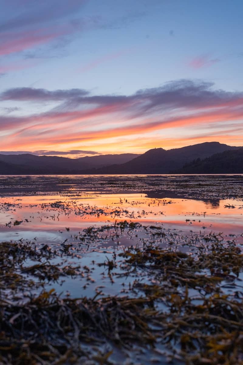 The sun is setting over a body of water