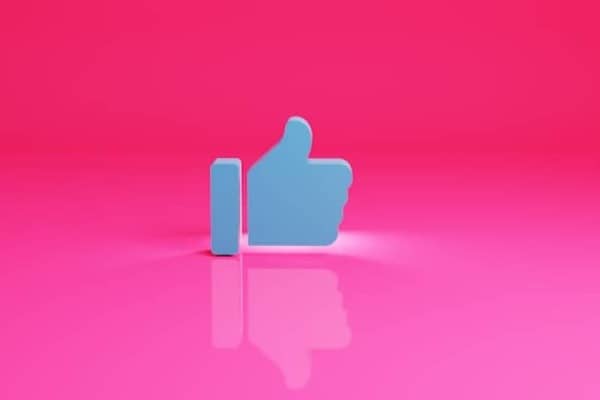 a thumbs up sign on a pink background