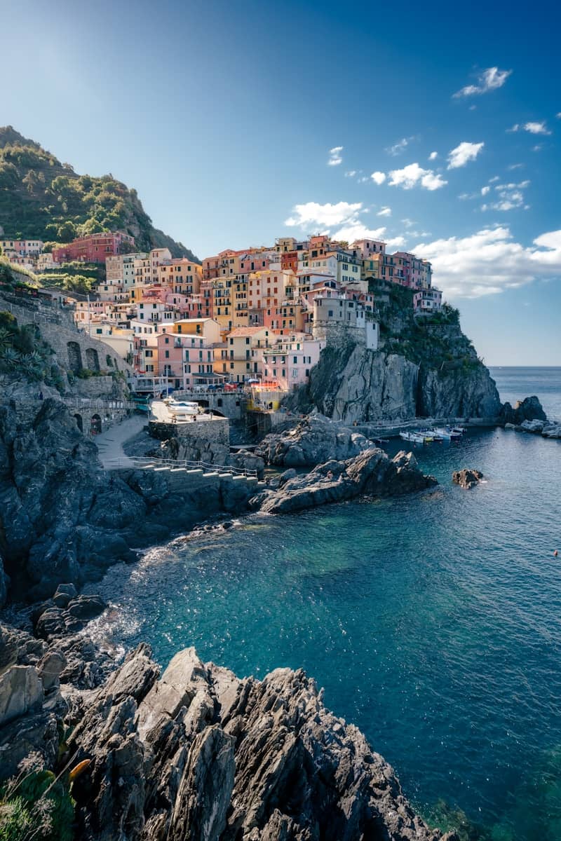 A coastal village sits on a rocky cliff.