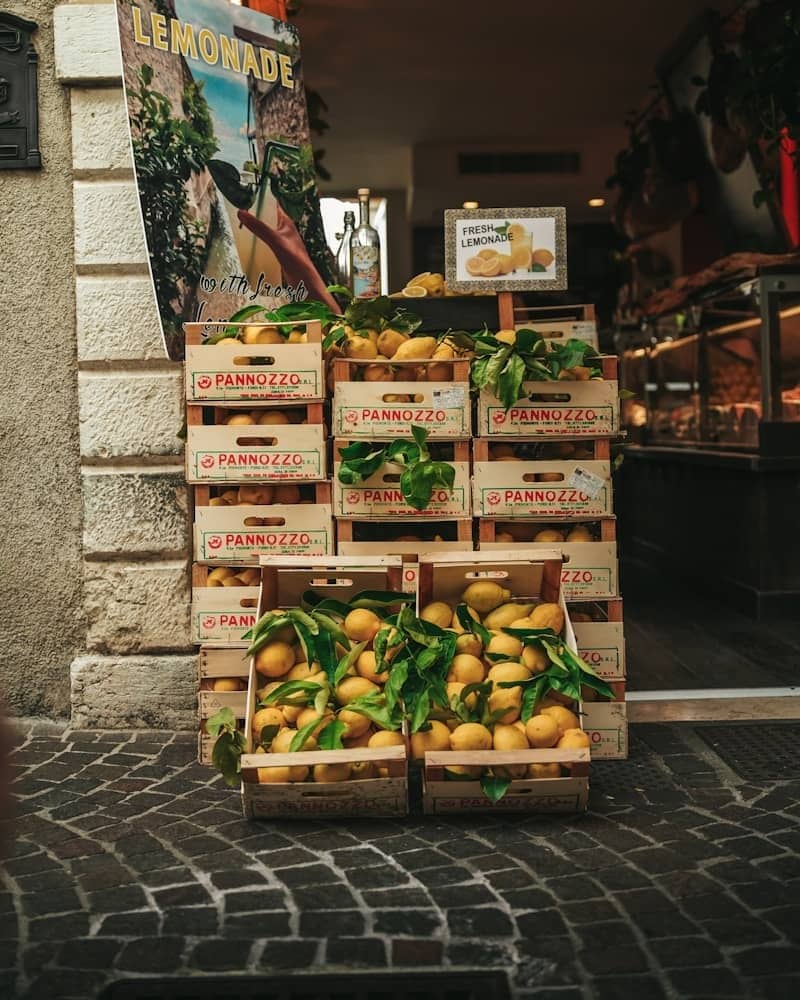 Fresh lemons are stacked outside a shop.