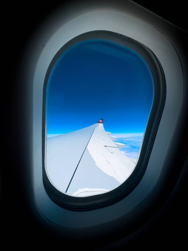 Looking out of an airplane window at the sky.