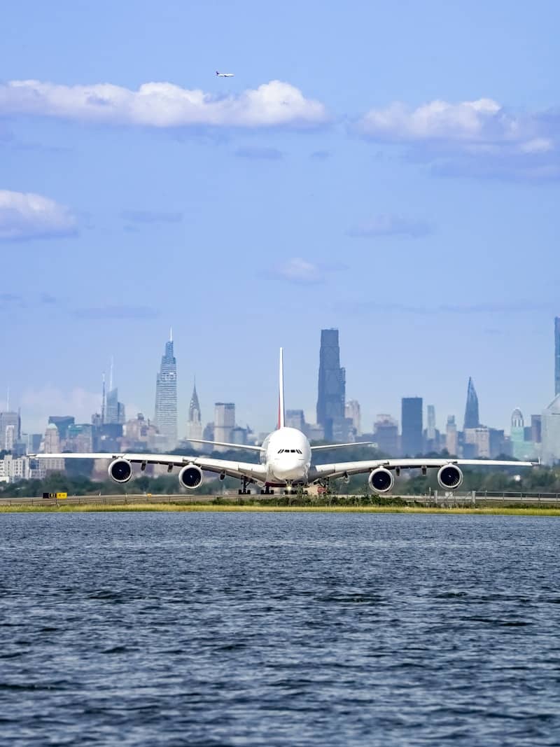 Airplane on runway with new york city skyline