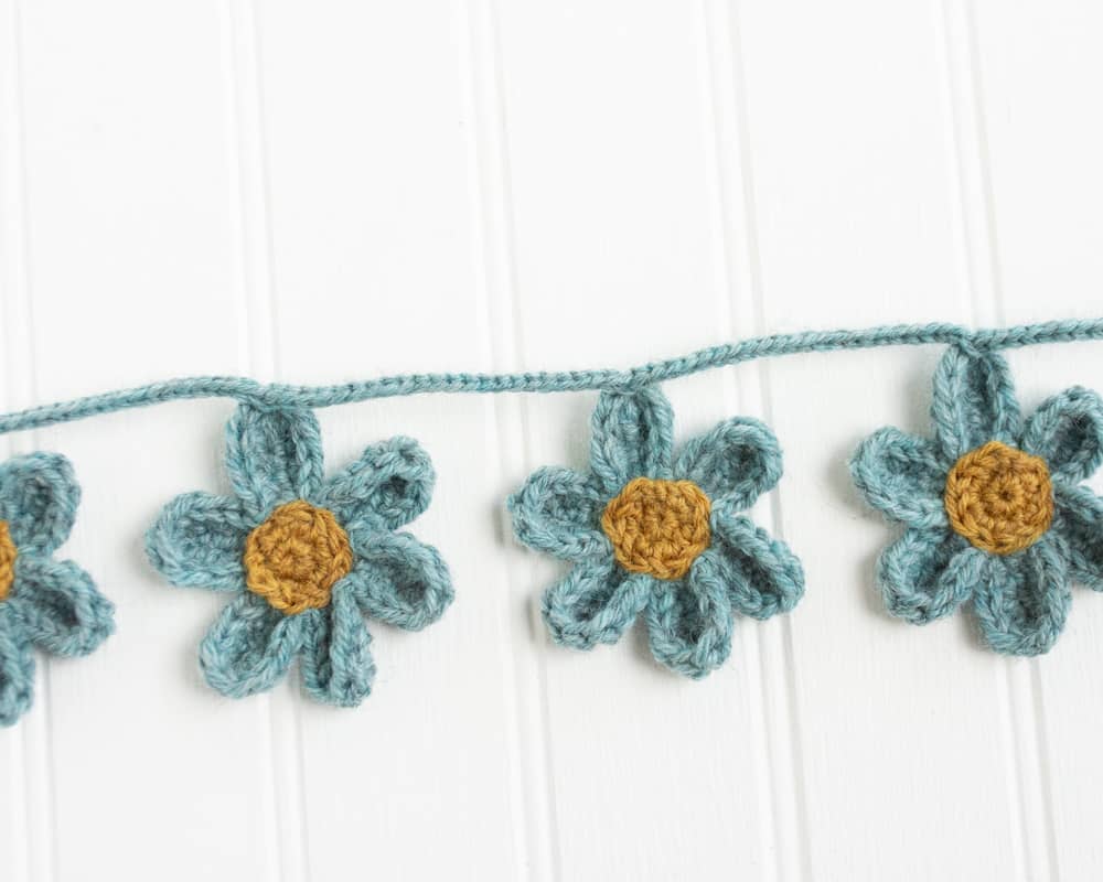 blue and yellow crochet daisy garland