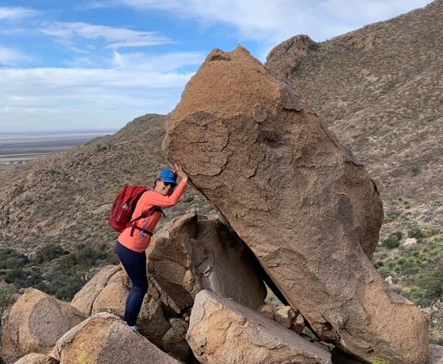 Lifting a heavy rock while hiking