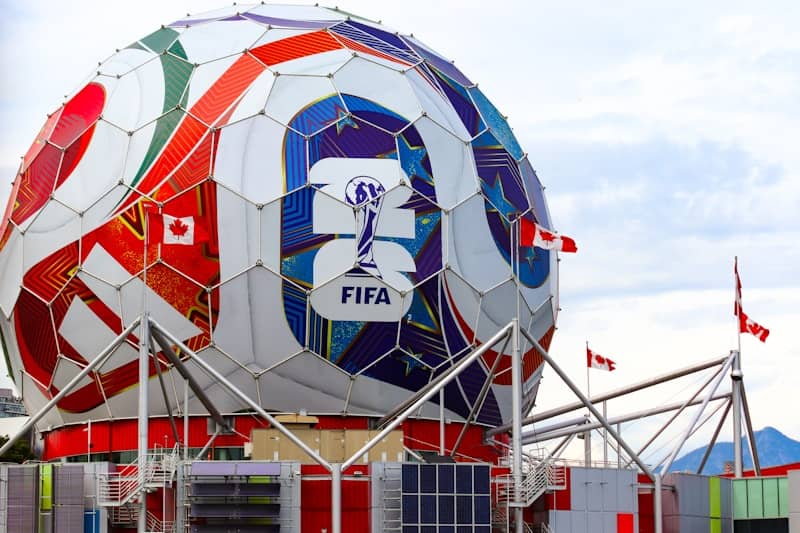 A giant colorful fifa soccer ball structure with canadian flags.