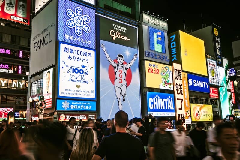 Crowded street with bright neon signs at night