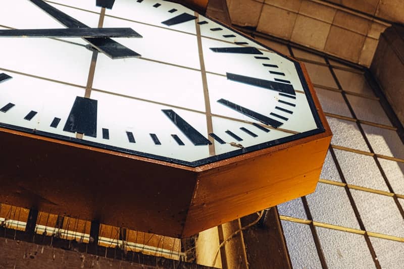 A large clock is hanging from the ceiling.