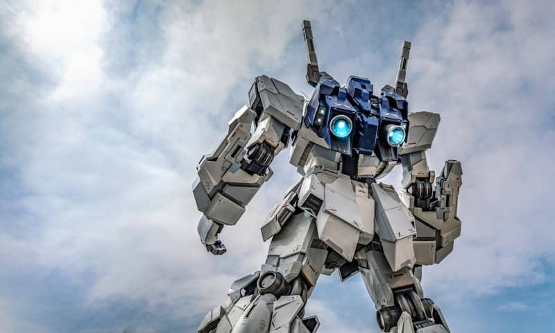 Giant white robot with blue glowing eyes against sky