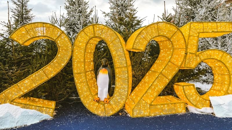 A penguin standing in front of a sign that says 205