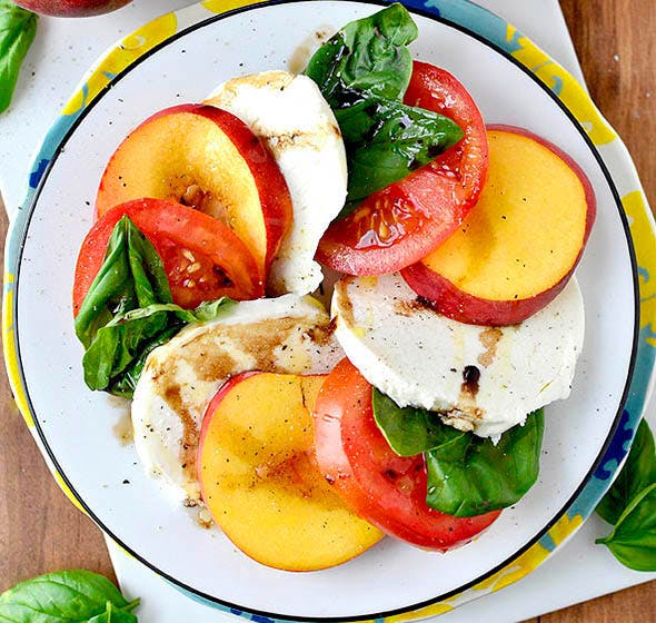 plate of peach caprese salad