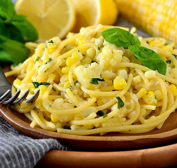 plate of sweet corn pasta with basil