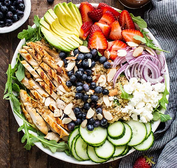 overhead of berry chicken quinoa bowll