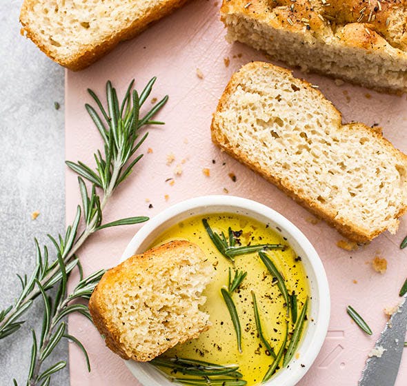 Sliced focaccia with bowl of olive oil
