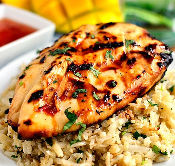 plate of chicken on bed of rice