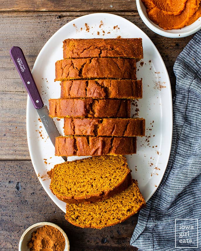 Loaf of gluten free pumpkin bread sliced on the counter
