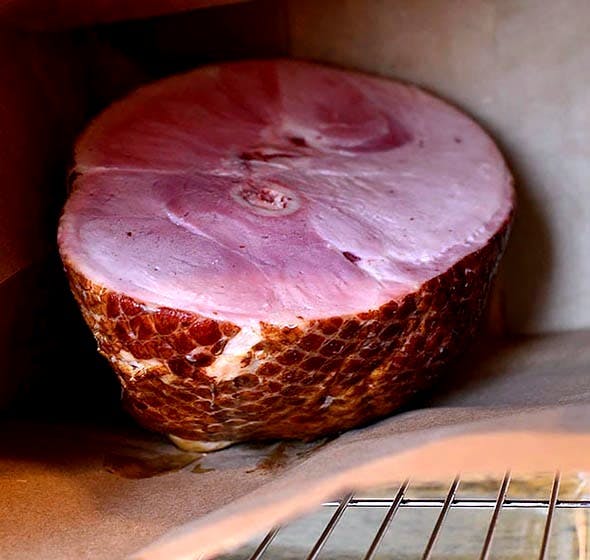 ham in brown bag in oven