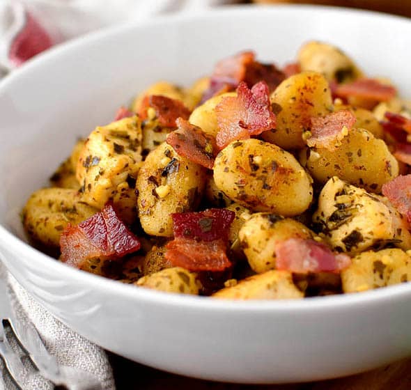 bowl of crispy chicken, bacon, pesto gnocchi skillet