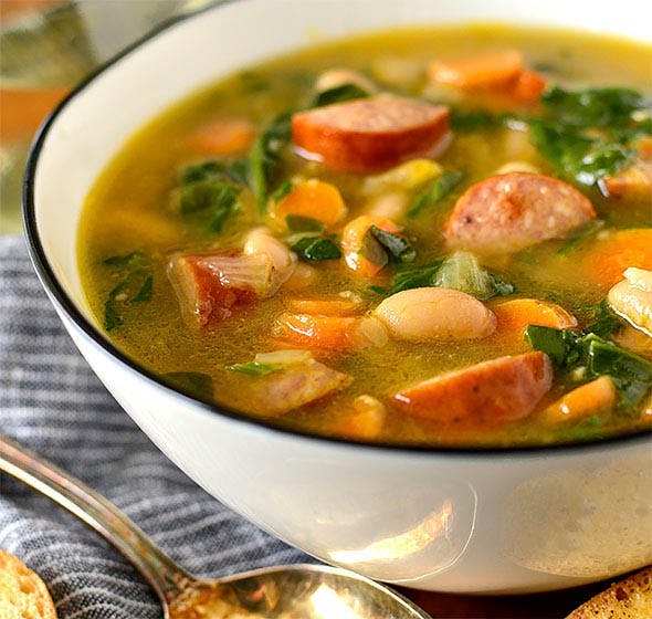 bowl of smoked sausage, white bean and spinach soup