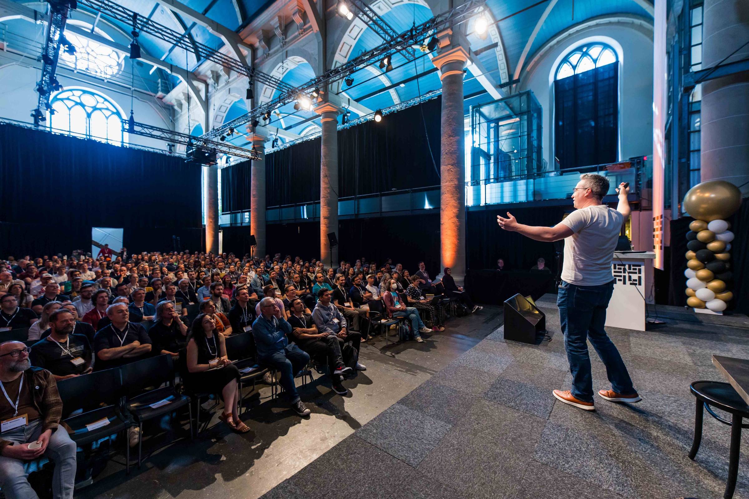 Me on stage at CSS Day, with a large audience watching my talk
