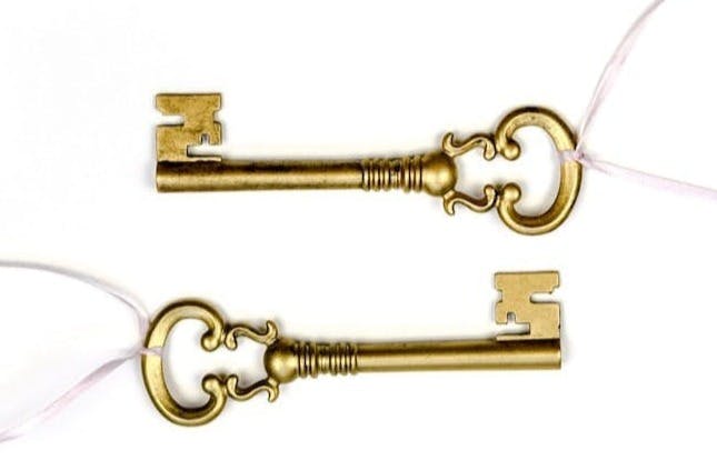 two gold-colored skeleton keys