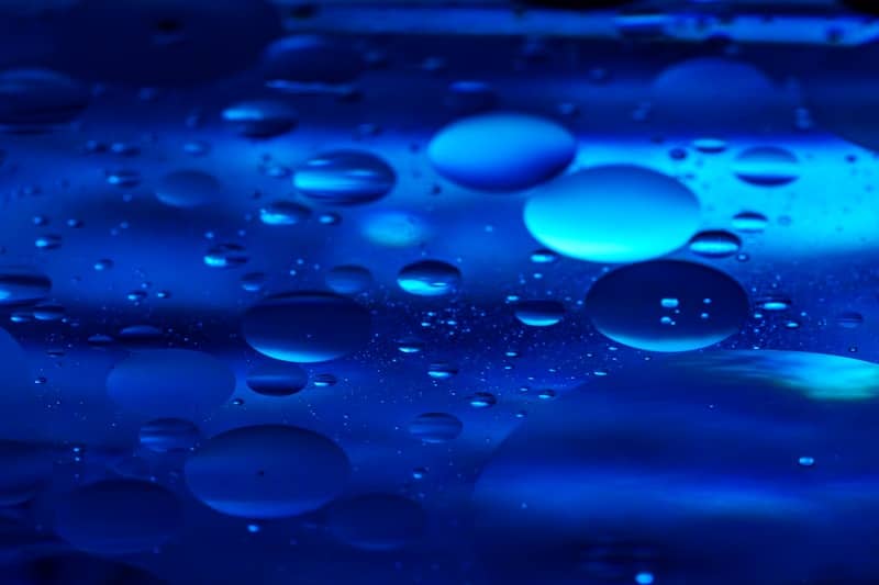 Abstract blue background with water droplets.