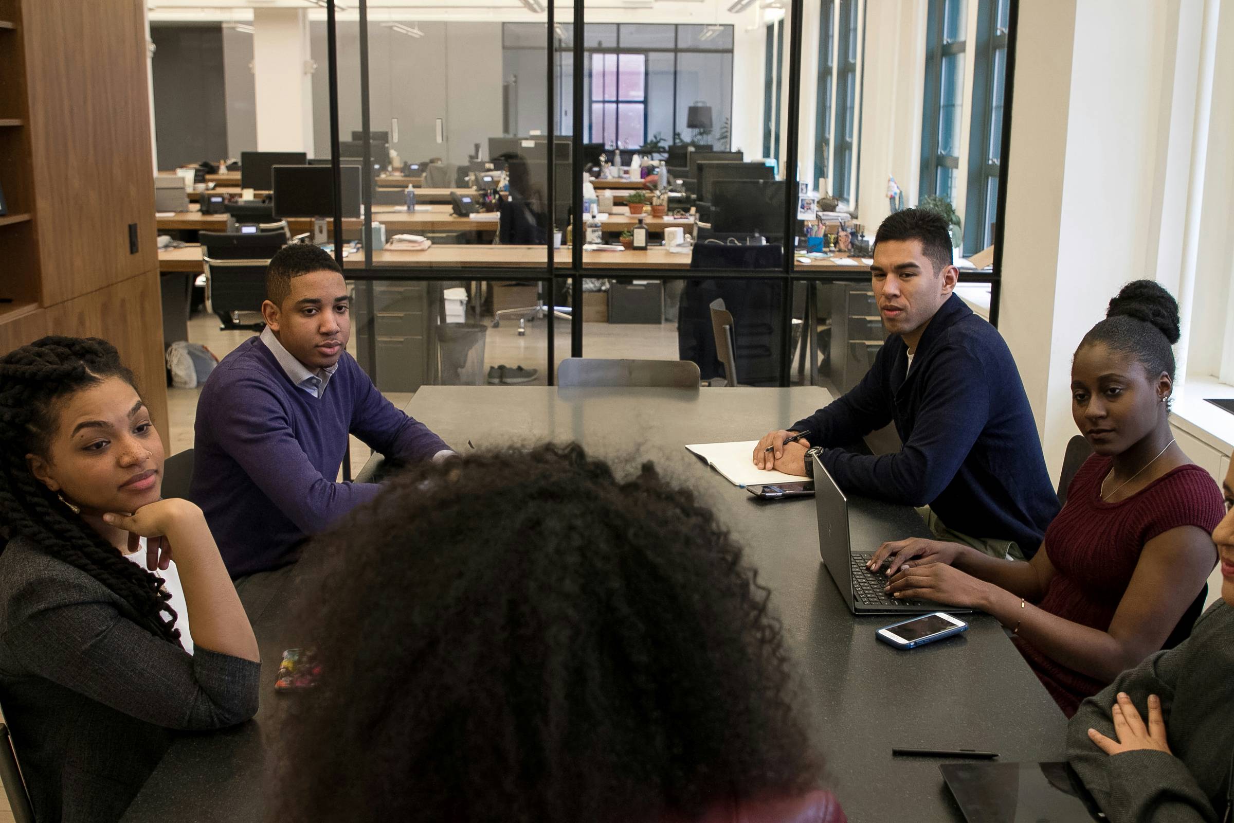 People sitting in a boardroom talking