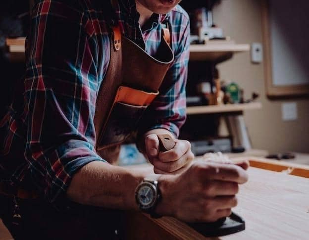 a man working on a piece of wood