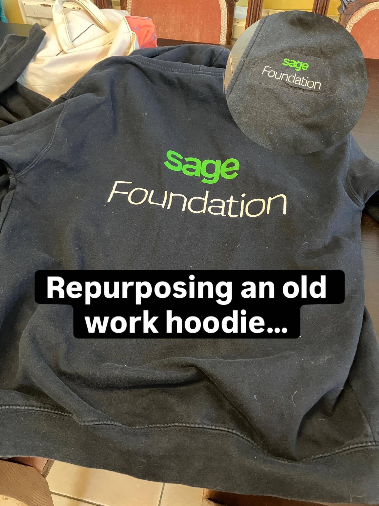 A black hoodies with a large Sage Foundation logo.
