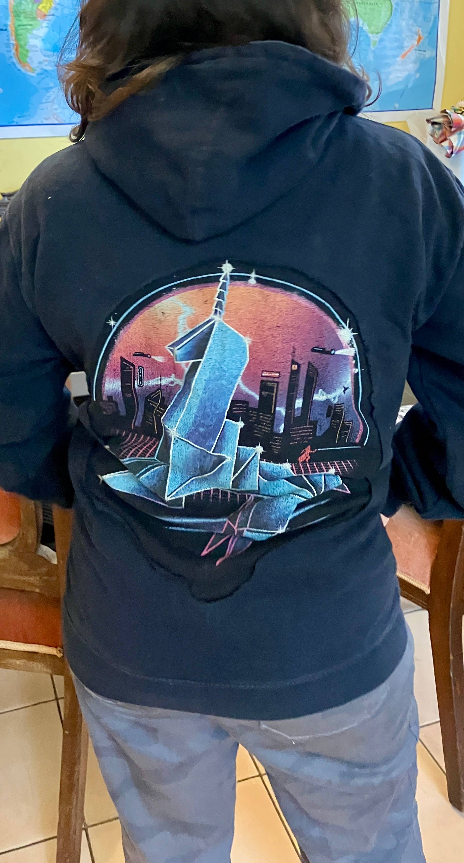 A black hoodie with a -shirt design replacing the logo.