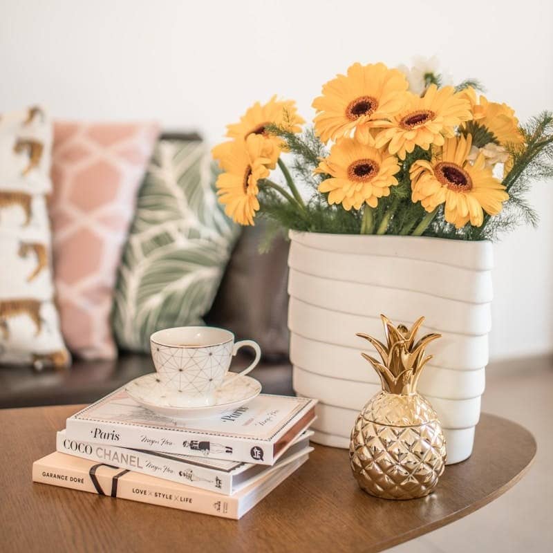 yellow flower on white ceramic vase