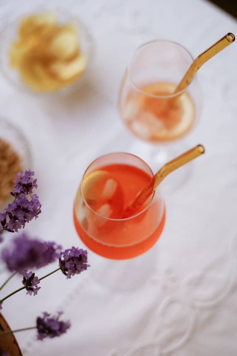 Cocktails with a side of snacks are nicely presented.