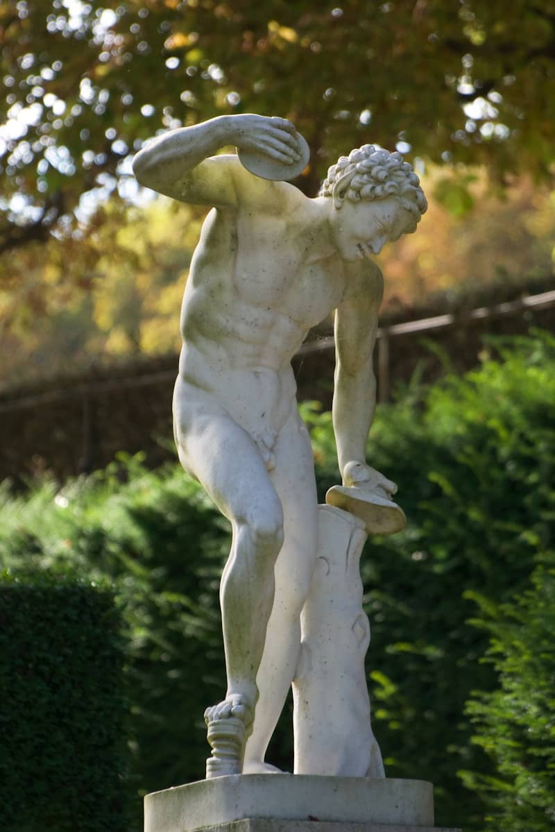 A statue of a man holding a skateboard