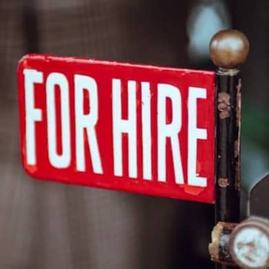 shallow focus photography of red and white for hire signage