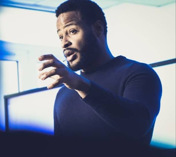 A man standing in front of a projection screen