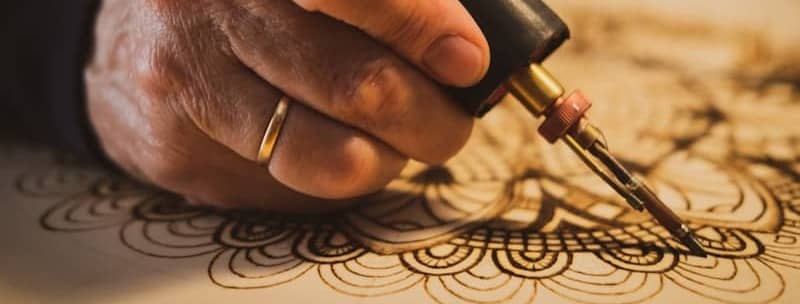 person holding red and black hand tool