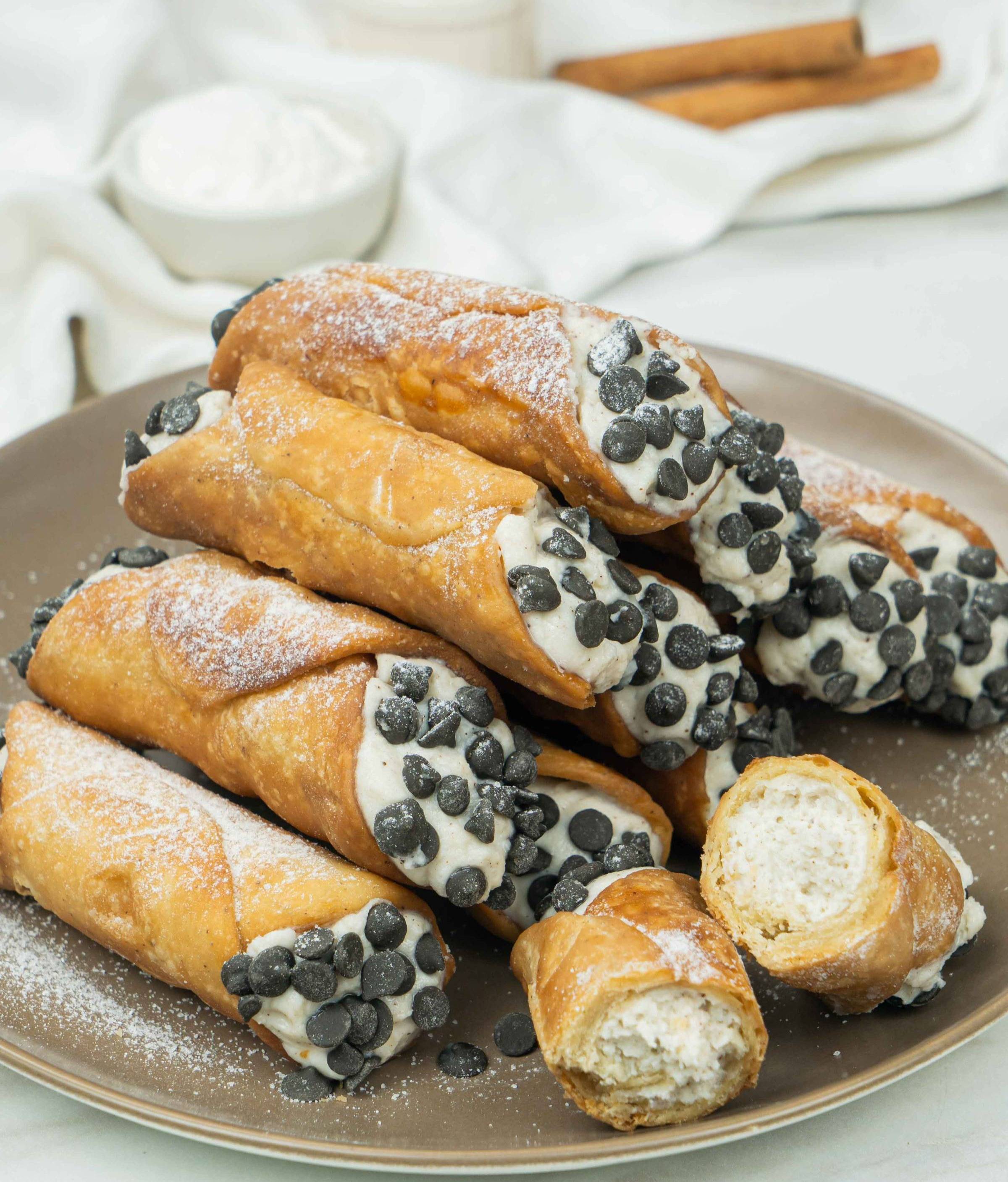 Classic Italian cannoli filled with sweet ricotta cream and finished with powdered sugar.