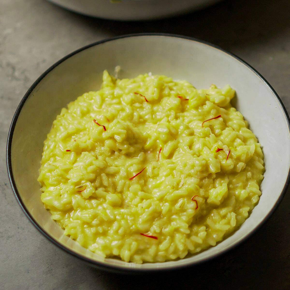 Classic risotto alla Milanese with saffron, creamy rice, butter, and Parmesan.