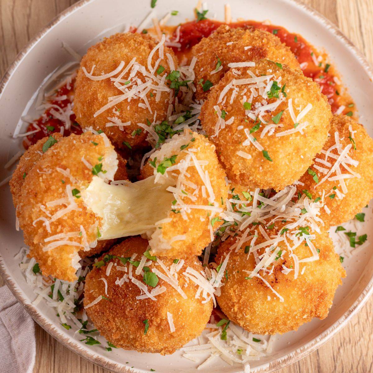 Classic Italian arancini with golden fried rice balls and a creamy savory filling.