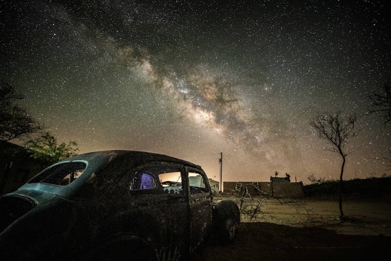 black suv on brown field under starry night