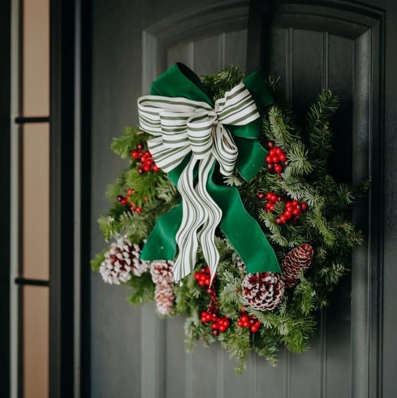 A christmas wreath hanging on a door