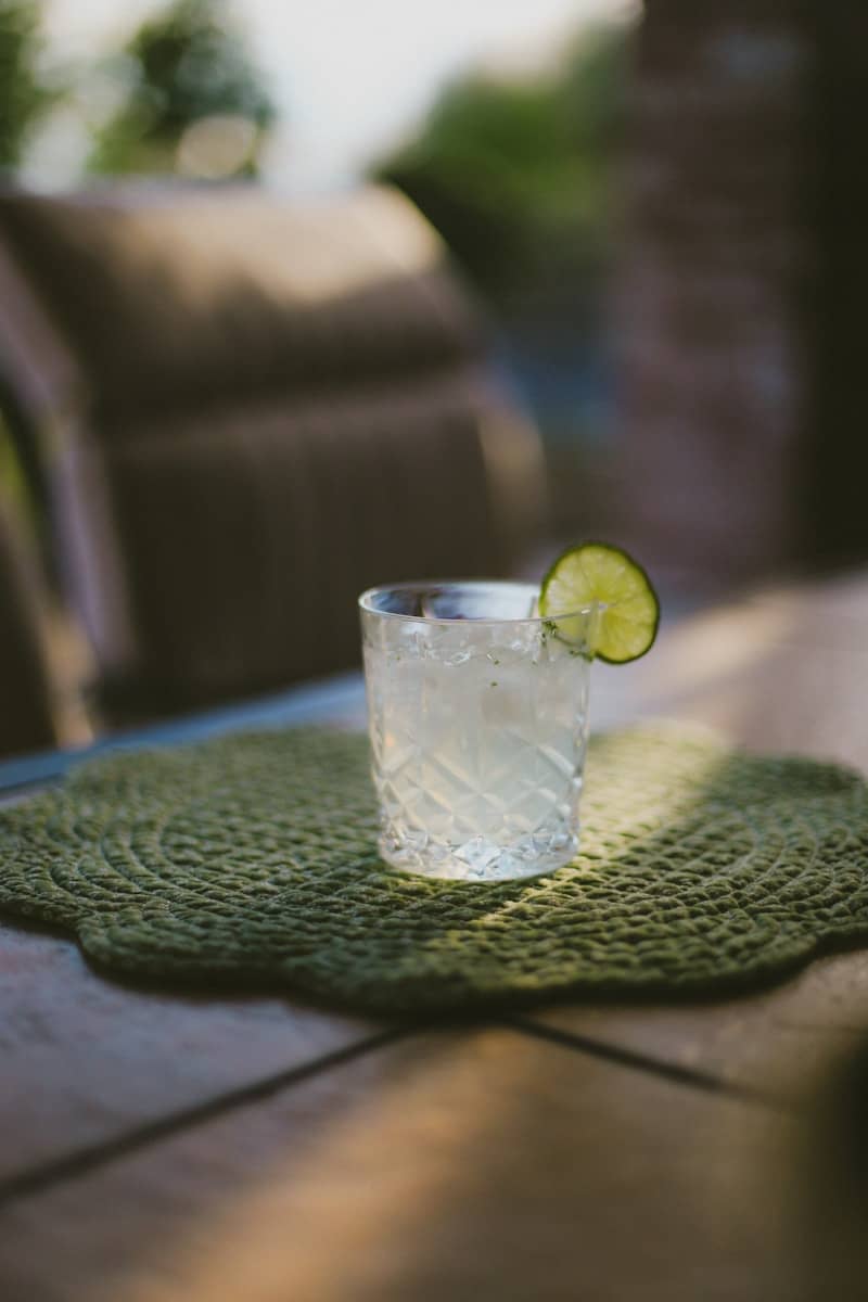 A refreshing drink with lime on a table.