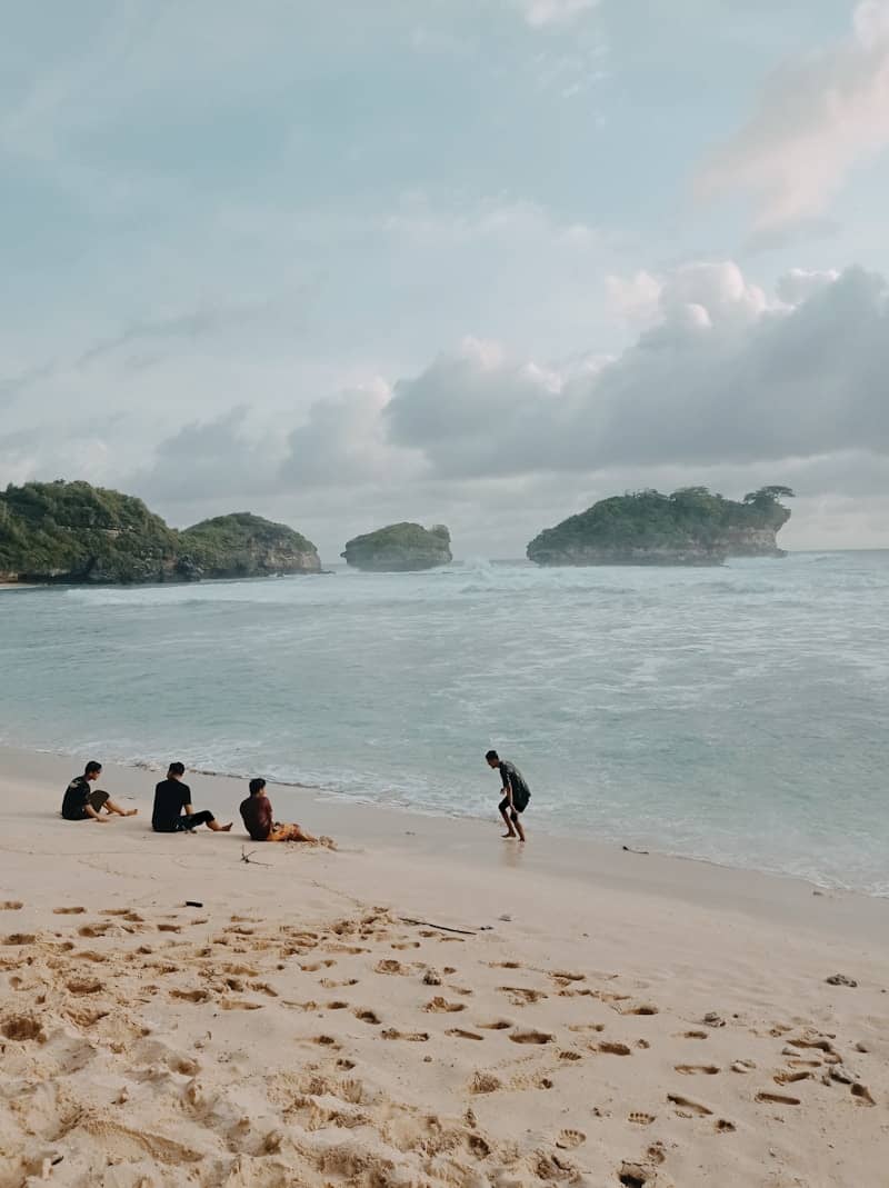 People enjoy a beautiful beach day by the ocean.