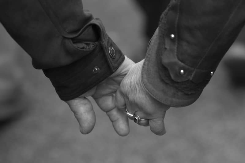 Two hands holding each other tightly