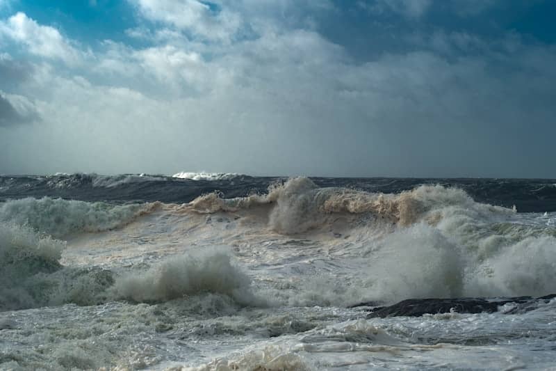 Crashing ocean waves under a stormy sky