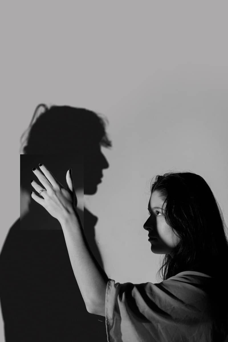 Woman touches shadow of a man