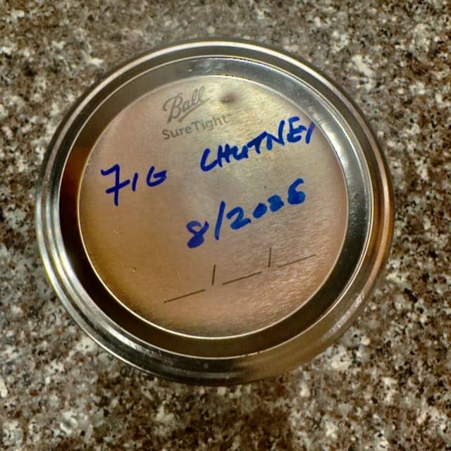 The lid, hand-labeled FIG CHUTNEY 8/2026