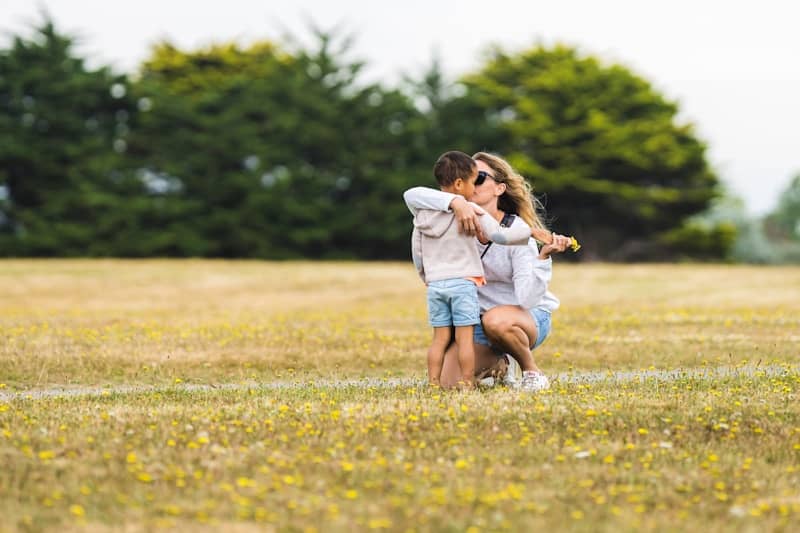 a couple of people that are standing in the grass