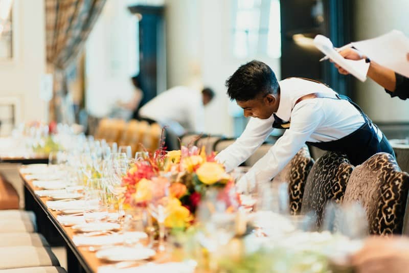 Catering staff preparing a table for an event.
