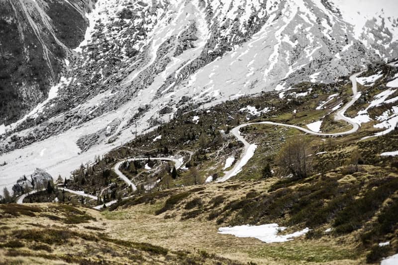 A winding road leads to mountain peaks.