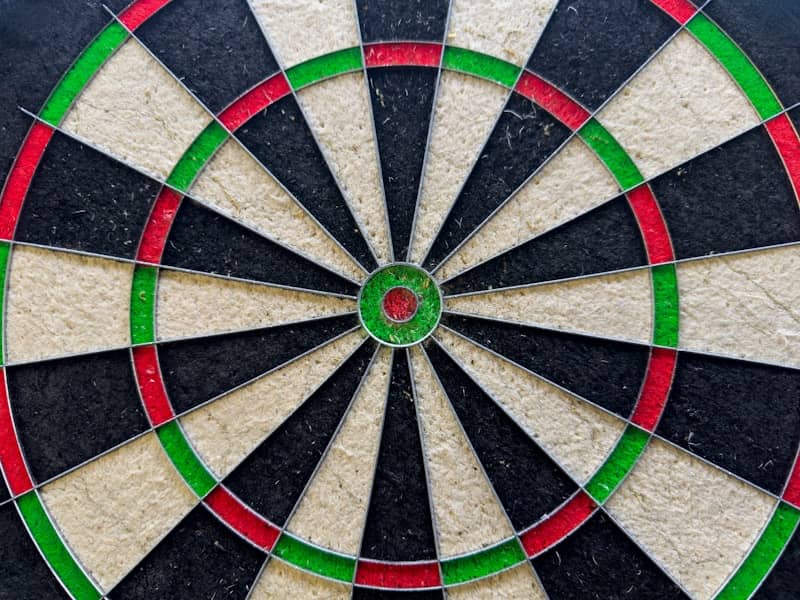Close-up of a dartboard with colorful sections.